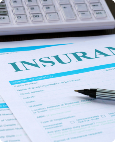Insurance form with pen and calculator.