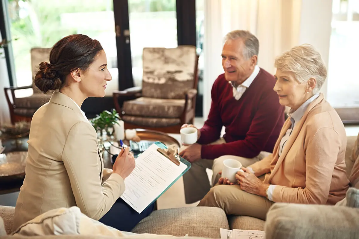 Advisor meeting with senior couple at home.